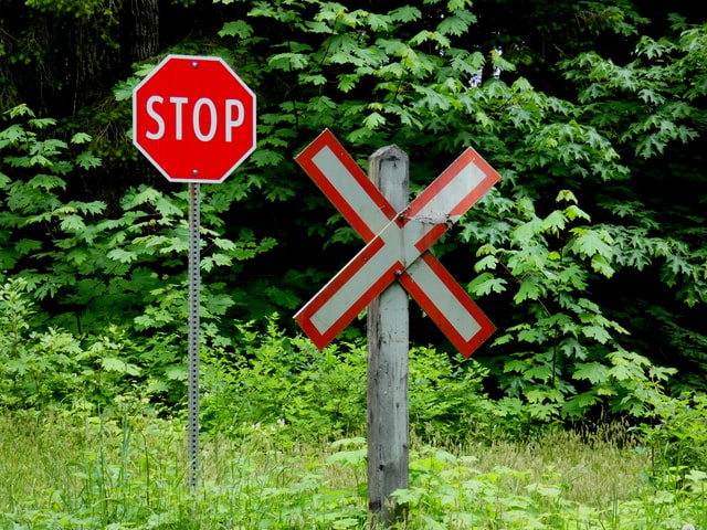 panneau stop et signalétique de train en forme de croix